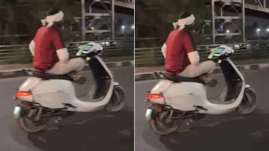 स्कूटी चलाते समय फोन से गिरने से बचा, देखें वीडियो