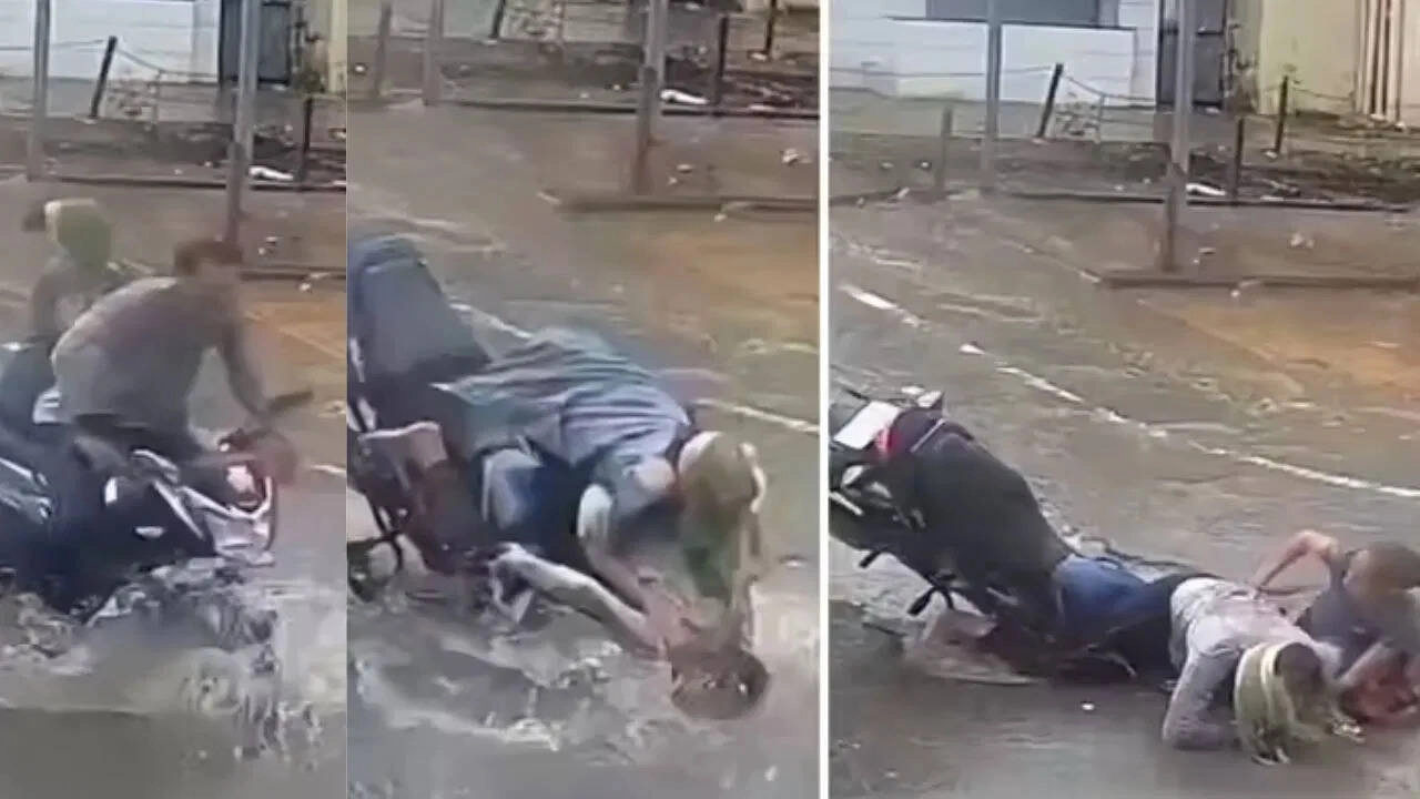 Rain Causes Trouble: Couple on Bike Falls into Hidden Pothole